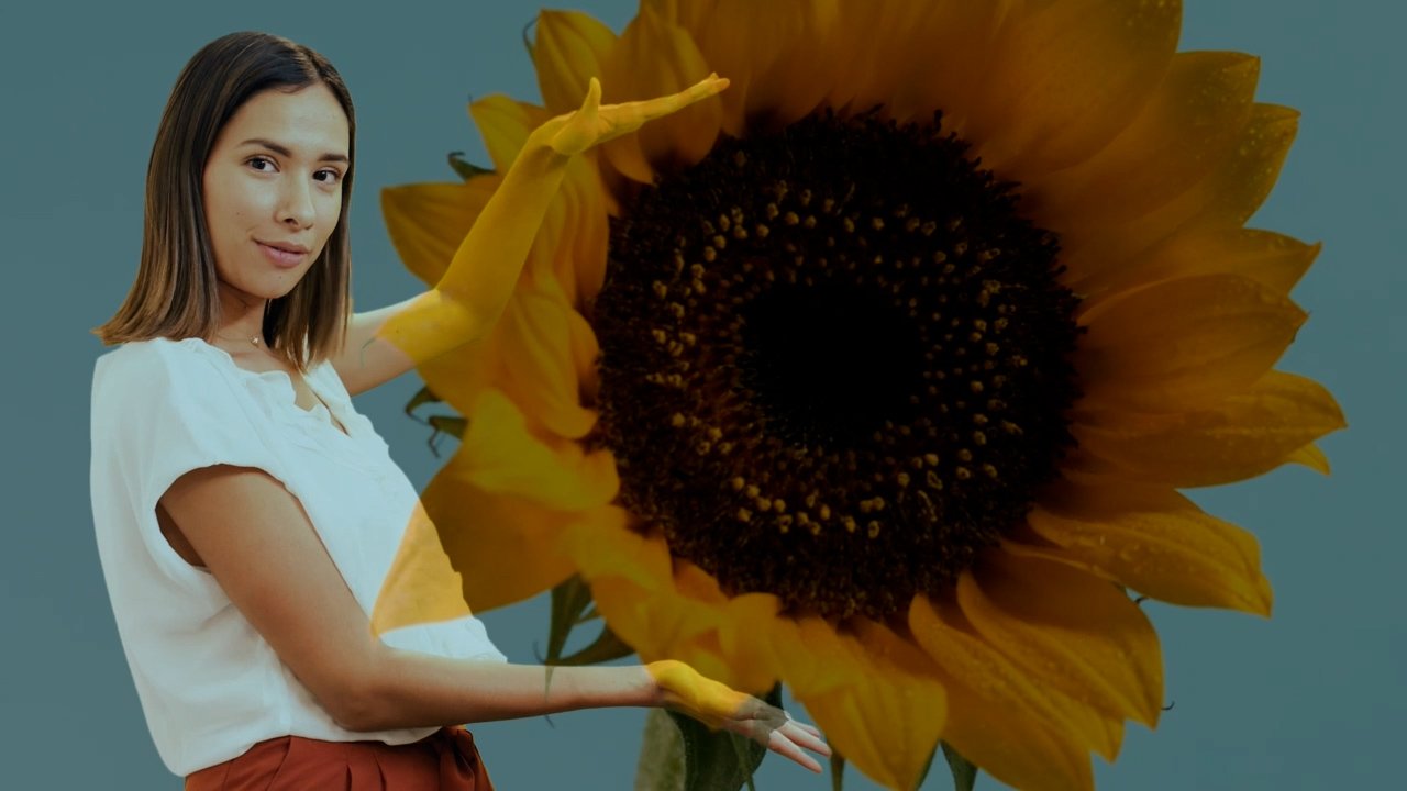 girl in white shirt showing sunflower